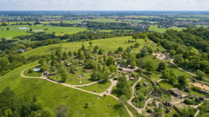 Wilde Avonturen in het Hart van Nederland: Hoe Ouwehands Dierenpark de Dierenwaareld Veranderde Aerial view of Ouwehands Dierenpark in Rhenen, Netherlands, showcasing the lush landscape, Berenbos (Bear Forest), animal enclosures, walking paths, and the surrounding Dutch countryside.